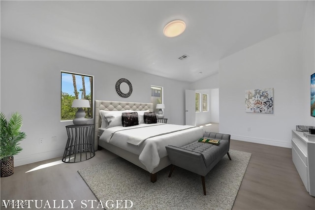 bedroom featuring lofted ceiling and wood-type flooring