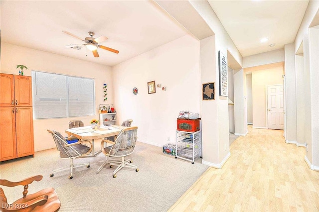 dining area featuring baseboards, light wood-style flooring, and a ceiling fan