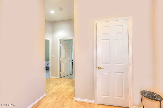 hallway featuring baseboards and light wood-style floors