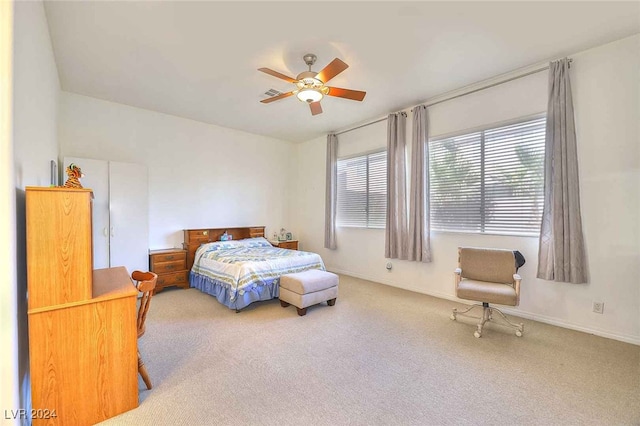 carpeted bedroom with baseboards and a ceiling fan