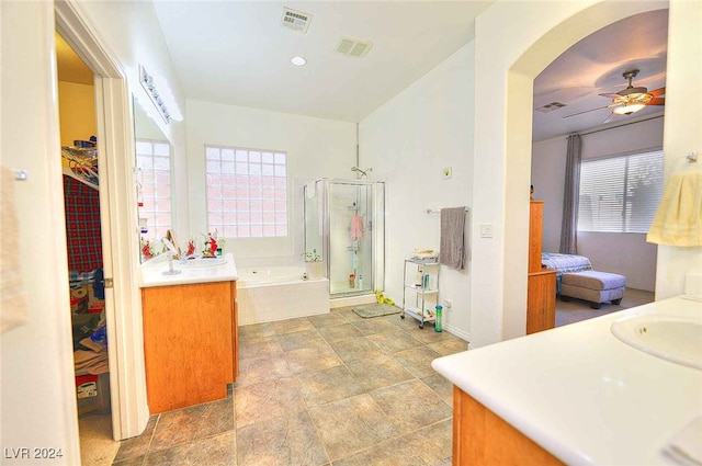 full bath with a bath, a wealth of natural light, a stall shower, and vanity