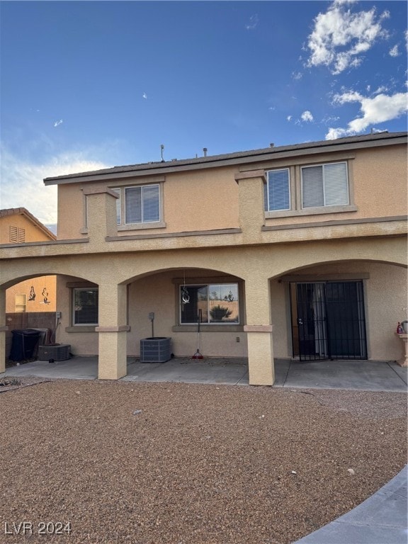 rear view of house featuring a patio and central AC