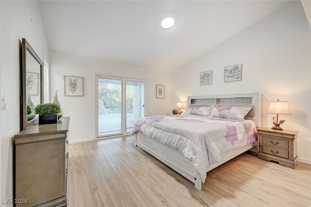 bedroom featuring high vaulted ceiling, light hardwood / wood-style floors, and access to outside