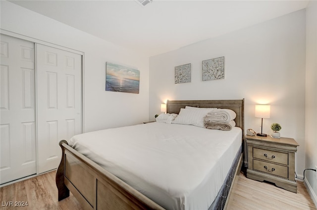 bedroom with a closet and light hardwood / wood-style floors