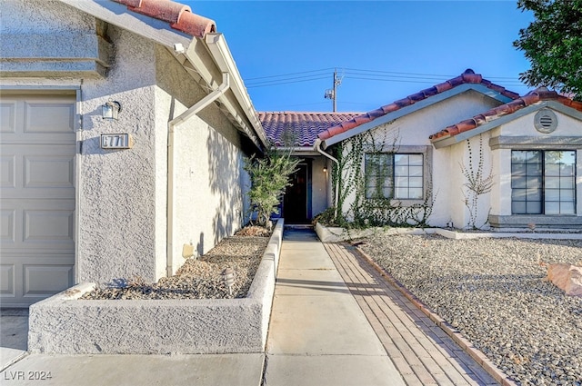 view of exterior entry featuring a garage