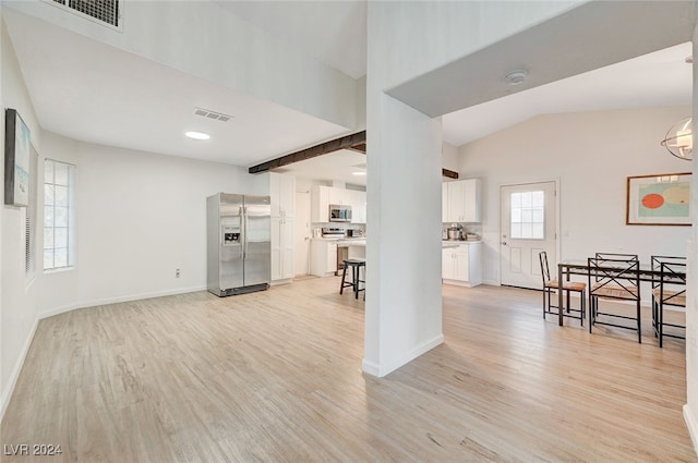 living room with light hardwood / wood-style flooring and vaulted ceiling