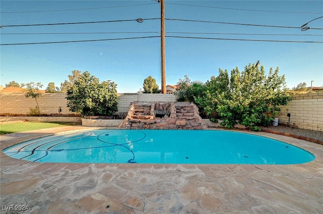 view of swimming pool with a patio area