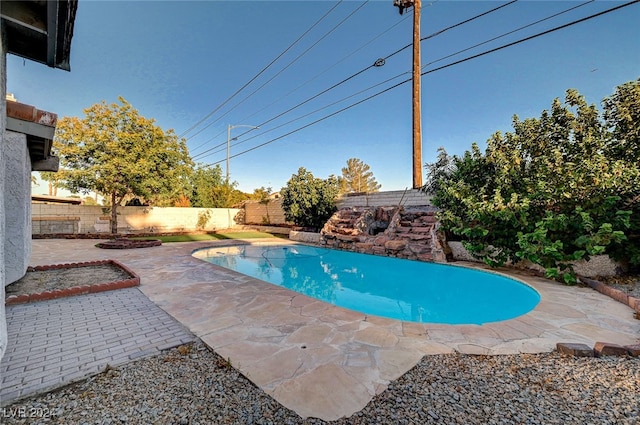 view of swimming pool with a patio area