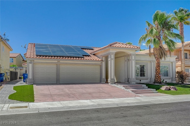 view of front of home with solar panels and a garage