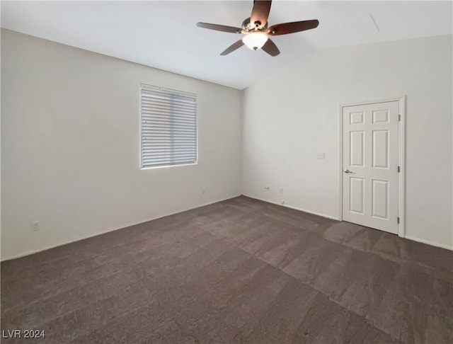 carpeted empty room featuring ceiling fan and vaulted ceiling