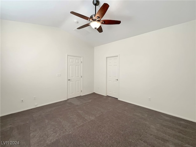 unfurnished room featuring ceiling fan, vaulted ceiling, and dark carpet