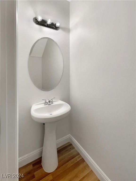 bathroom with hardwood / wood-style floors