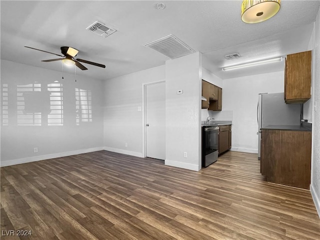 kitchen featuring ceiling fan, dishwasher, and dark hardwood / wood-style flooring