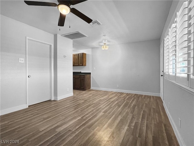 unfurnished living room with ceiling fan and wood-type flooring