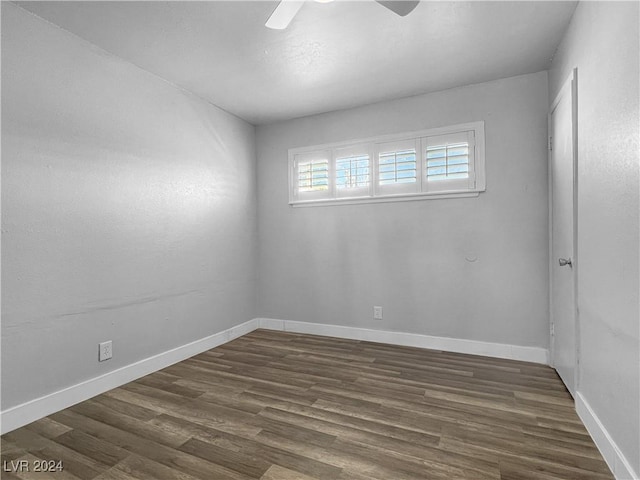 spare room featuring ceiling fan and dark wood-type flooring