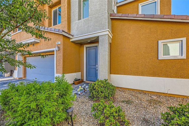 view of exterior entry with a garage