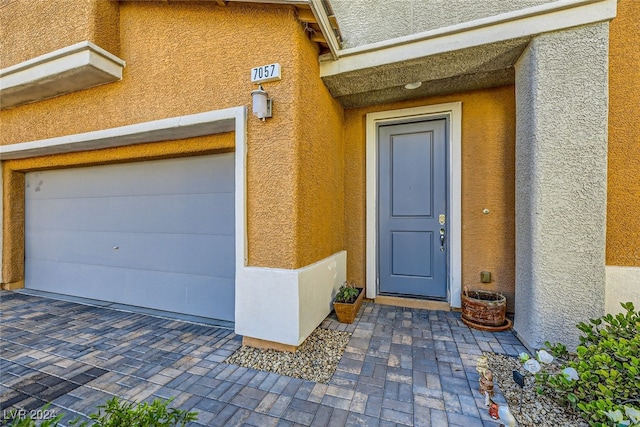 doorway to property with a garage