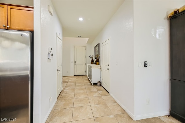 corridor featuring light tile patterned floors