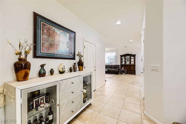 hall featuring light tile patterned floors