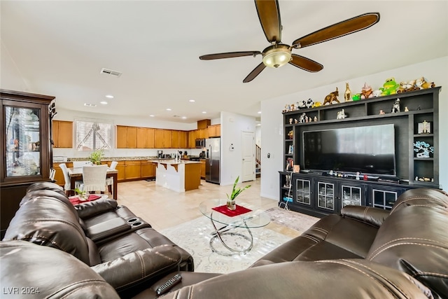 tiled living room with ceiling fan