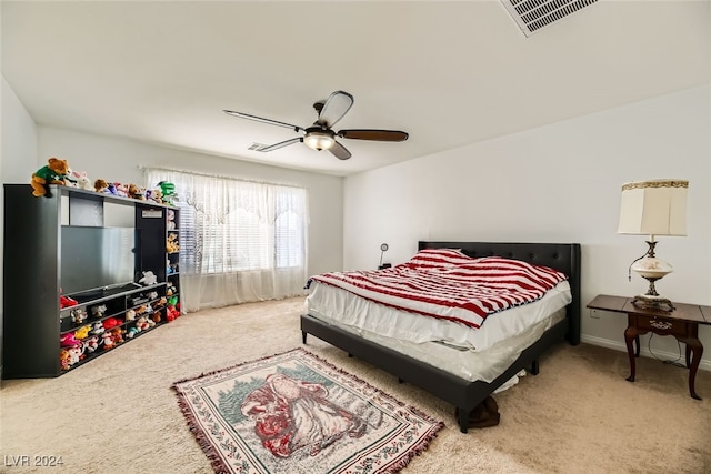 bedroom featuring ceiling fan and carpet