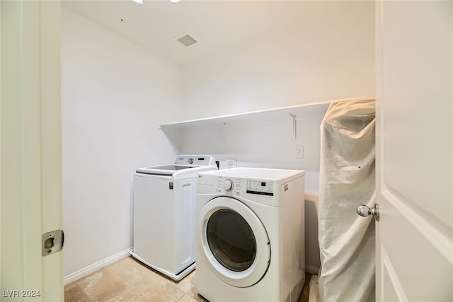 laundry room featuring light tile patterned flooring and washer and dryer