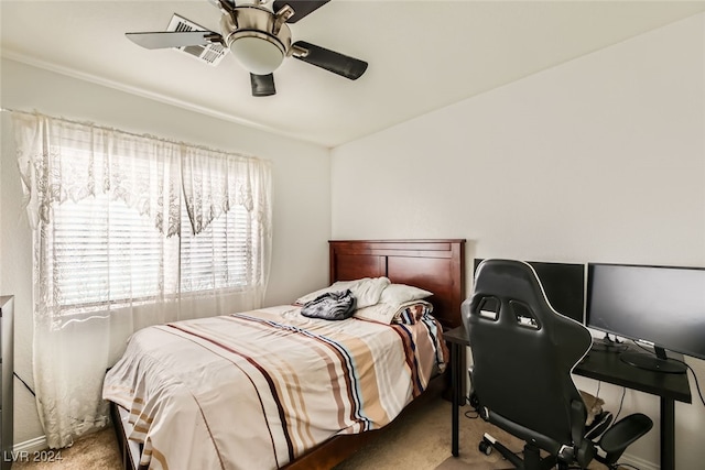 bedroom with ceiling fan and light carpet