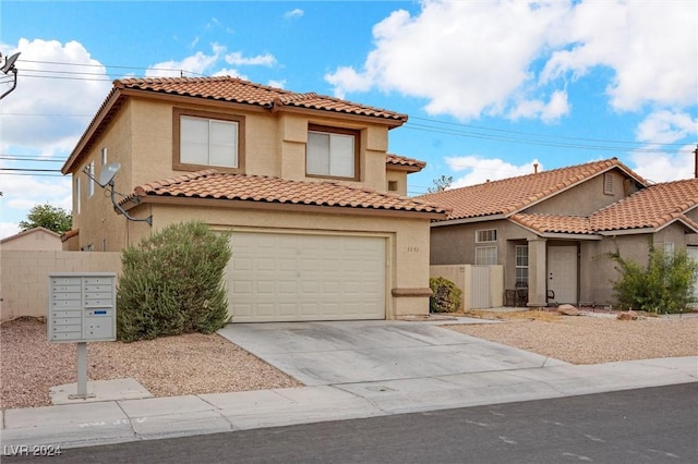 mediterranean / spanish house with driveway, fence, an attached garage, and stucco siding