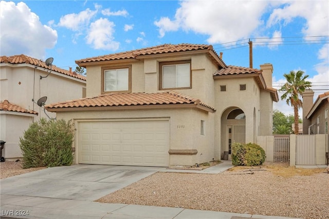 mediterranean / spanish home featuring a garage, concrete driveway, a chimney, a gate, and stucco siding