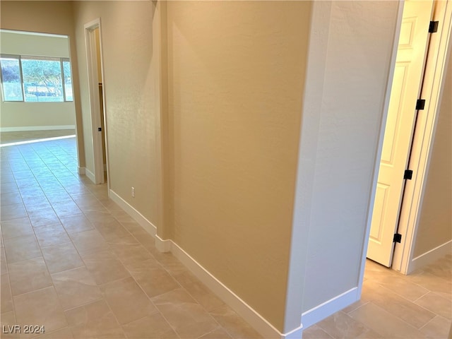 hallway with light tile patterned floors