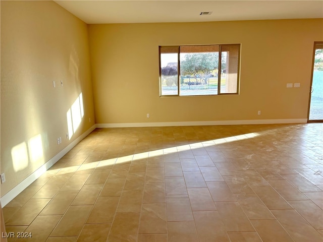 spare room with light tile patterned floors