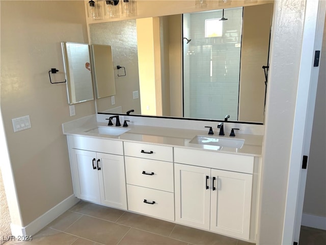 bathroom featuring tiled shower, tile patterned floors, and vanity