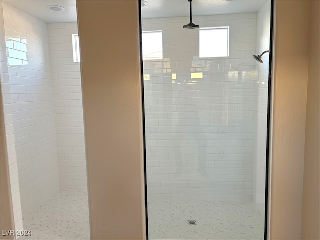 bathroom with tiled shower