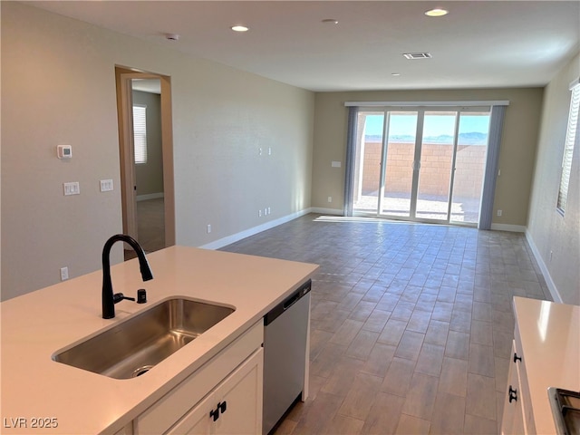 kitchen featuring white cabinets, dishwasher, and sink