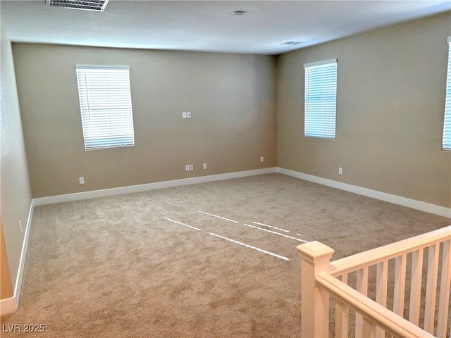 spare room with light carpet and a healthy amount of sunlight