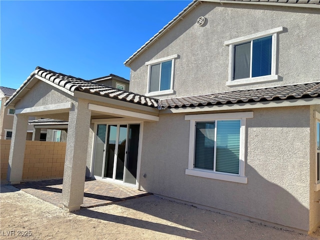 rear view of property featuring a patio