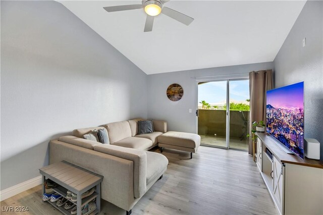 living room featuring ceiling fan, light hardwood / wood-style floors, and lofted ceiling