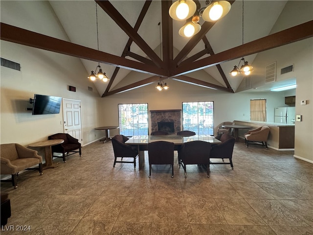 dining space with high vaulted ceiling and a notable chandelier