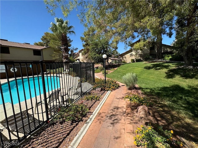 view of swimming pool featuring a lawn