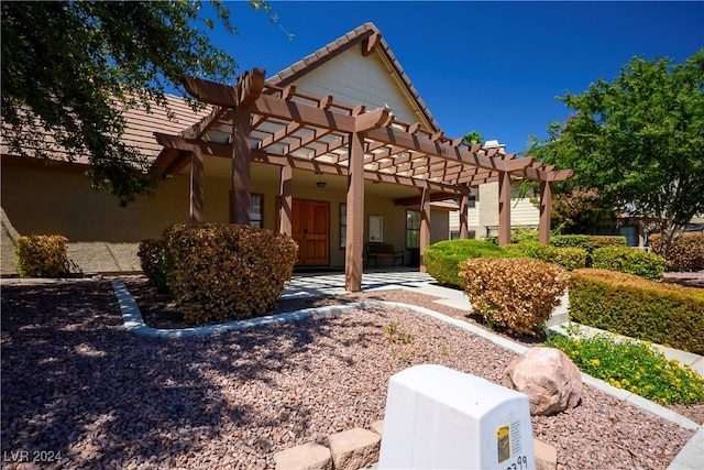 view of front of home featuring a pergola and a patio