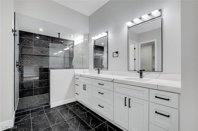 bathroom featuring marble finish floor, double vanity, a sink, and walk in shower