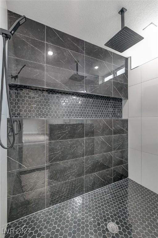 bathroom with a tile shower