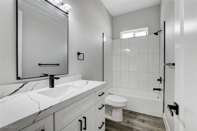 bathroom featuring shower / tub combination, vanity, toilet, and wood finished floors