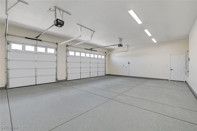 garage with baseboards and a garage door opener