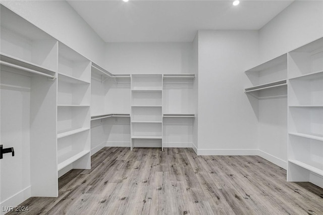 walk in closet featuring light hardwood / wood-style flooring