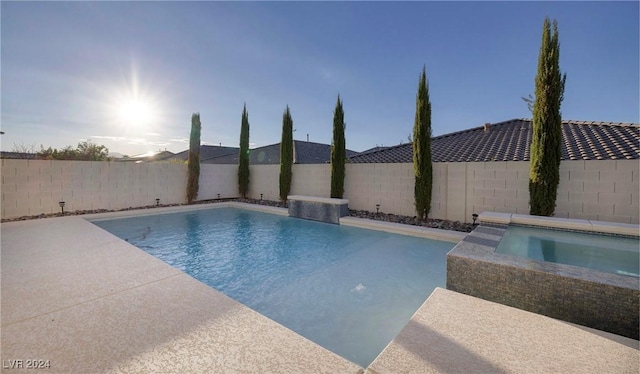 view of swimming pool featuring a fenced backyard, a patio, a fenced in pool, and an in ground hot tub