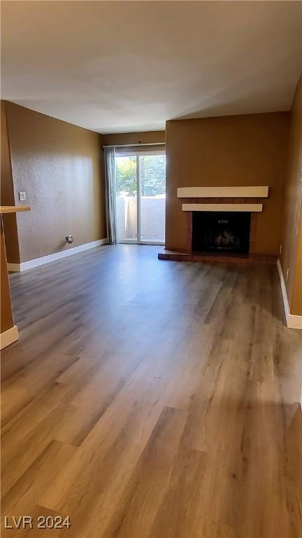 unfurnished living room with wood-type flooring