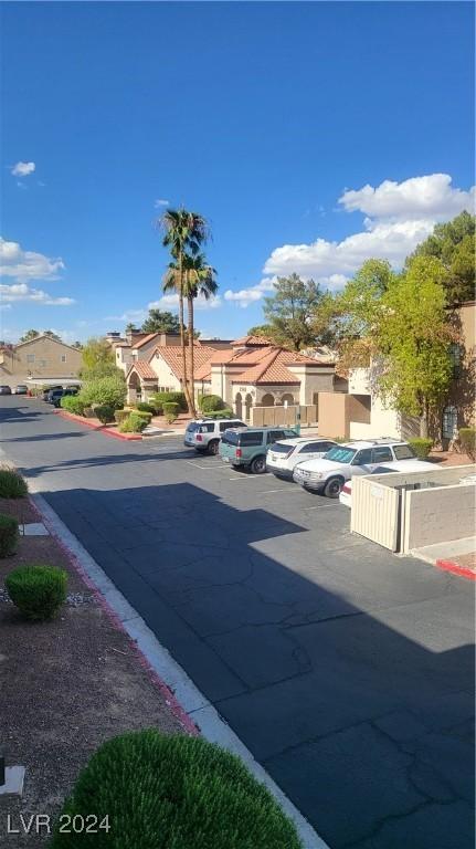 view of street with curbs, sidewalks, and a residential view