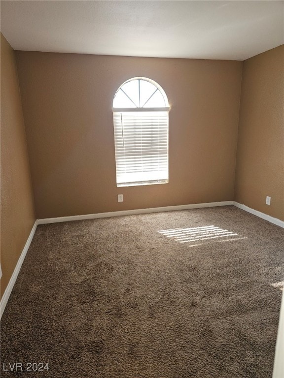 empty room with carpet and baseboards