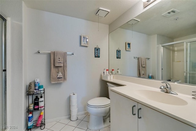 bathroom featuring visible vents, toilet, a stall shower, vanity, and tile patterned flooring